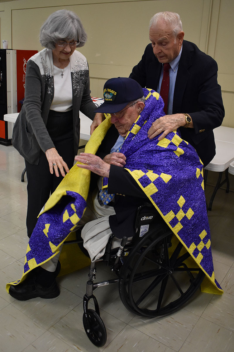 Korean War veteran receiving a Quilts of Valor