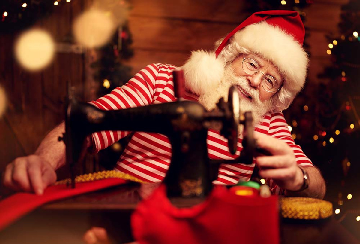 Santa at antique sewing machine, Adobe Stock